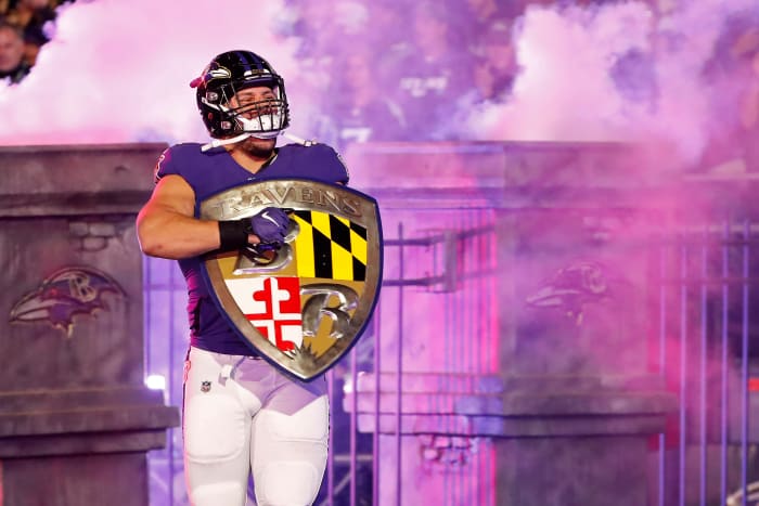 Baltimore Ravens fullback Patrick Ricard (42) carries the Ravens shield onto the field during player introductions prior to the Ravens game against the Tennessee Titans in a AFC Divisional Round playoff football game at M&T Bank Stadium.
